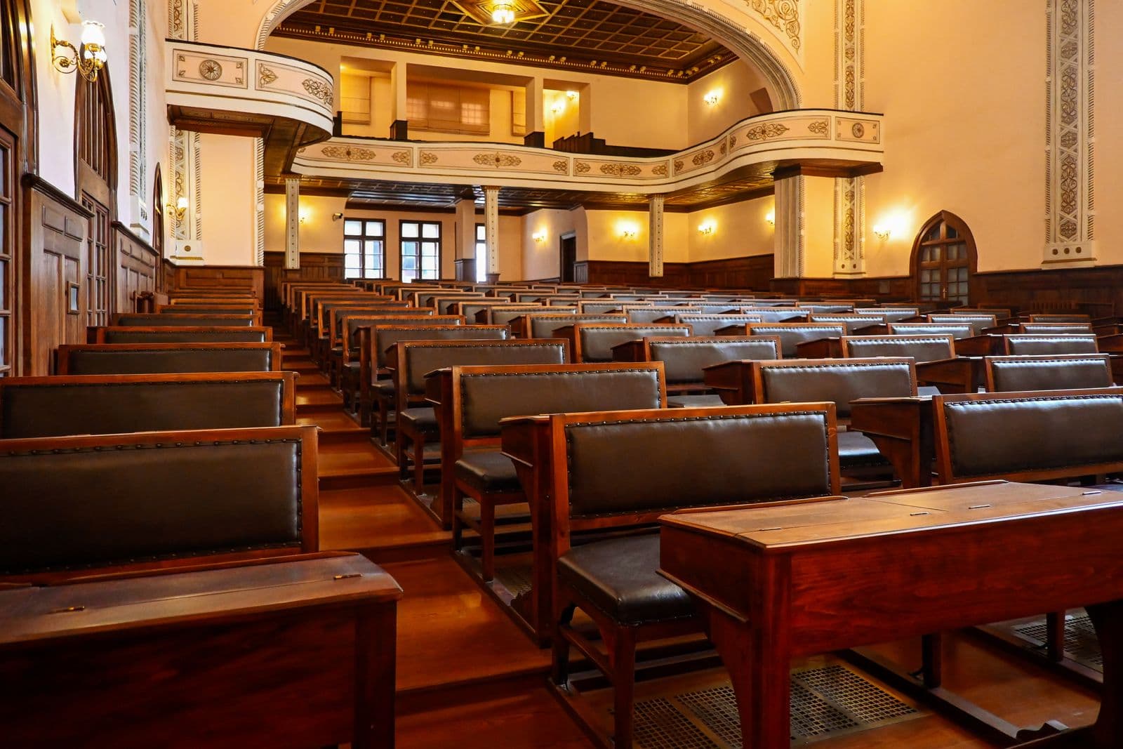 A historic university lecture theatre with tiered wooden benches